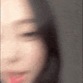 a blurry picture of a woman 's face with her eyes closed .