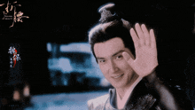 a man with a crown on his head is smiling and waving