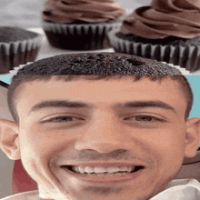 a close up of a man 's face with a cupcake on his head