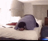a man laying on his back on a bed