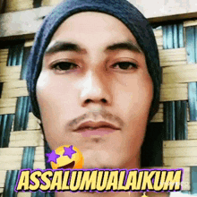 a man wearing a hat and a sticker that says ' assalamualaikum ' on it
