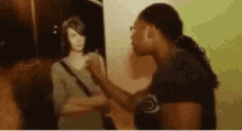 a woman is standing in front of a painting of a woman and a mannequin .