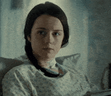 a woman in a hospital gown with a floral pattern