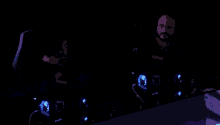 a man sitting in front of a computer with a predator logo on the back