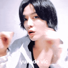 a close up of a man 's face with the words yui de vic written below him