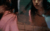 a woman looking at her reflection in a mirror