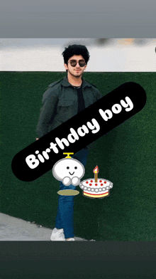 a man standing next to a birthday cake with a candle