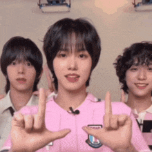 a group of young men are standing next to each other giving the middle finger