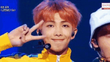 a close up of a person making a peace sign with their hands .