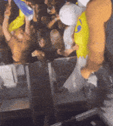 a crowd of people are gathered around a man in a yellow and white egg costume