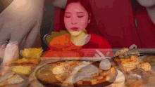 a woman is sitting at a table with a plate of food
