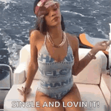a woman in a bikini is sitting on a boat .