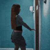 a woman is opening a door in a room with saturns returnz written on the bottom right