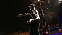 a man singing into a microphone on a stage