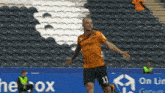 a soccer player with the number 11 on his shorts celebrates a goal