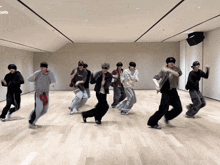 a group of young men are dancing in a room with the word angels on the bottom