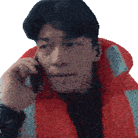 a man wearing a red life jacket talking on a cell phone