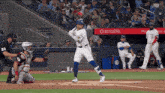 a baseball game is being played in front of a rogers sign