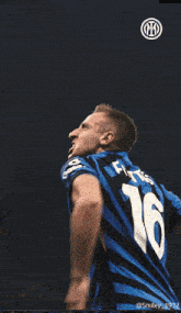 a soccer player wearing a blue and black jersey with the number 8 on it