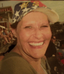 a woman wearing a patriotic hat is smiling for the camera