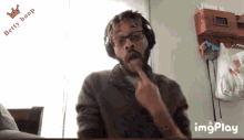 a man wearing headphones and glasses has a betty boop logo on the bottom
