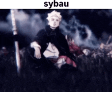 a blurry picture of a man standing in front of a crowd of people with the word sybau on the bottom .