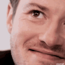 a close up of a man 's face with joequinngifs written on the bottom right