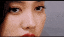 a close up of a woman 's face with red lipstick