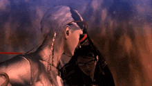 a man with glasses and a chain around his neck kisses another man