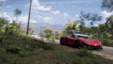a red sports car is driving on a dirt road