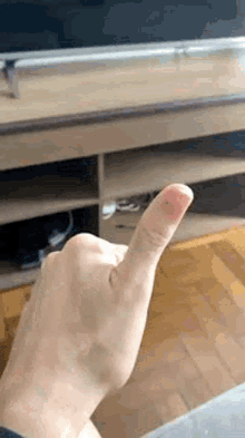 a close up of a person 's finger with blood on it in front of a television .