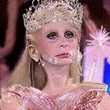 a close up of a woman wearing a crown and a tiara .