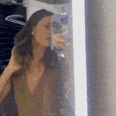 a woman is taking a selfie in front of a mirror with margaritosgif written on the bottom