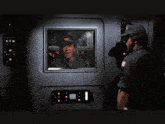a man in a military uniform salutes in front of a screen