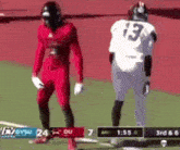 a football player with the number 13 on his jersey is standing next to another player