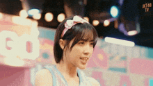 a girl with a headband that says jkt48 tv on it