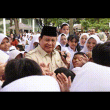 a man in a hat is surrounded by children