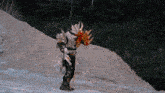 a monster is standing on a dirt hill with a sword