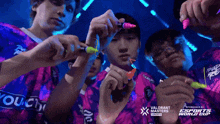 a group of people holding markers in front of an advertisement for the valorant masters toronto esports world cup