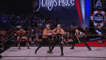 a wrestling match is going on in front of a sign that says double vegas