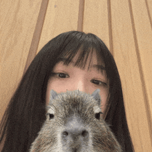 a close up of a woman holding a squirrel