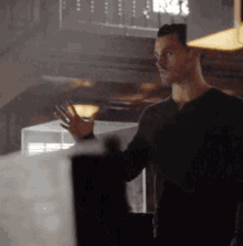 a man in a black shirt is standing in a room