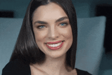 a close up of a woman 's face smiling