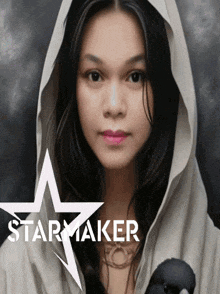 a woman wearing a hooded cape with a star maker logo