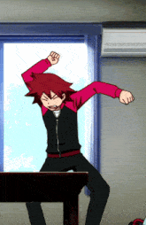 a man in a red and black jacket is standing on a table