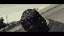 a close up of a man 's face with a few waves in his hair