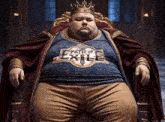 a fat man wearing a path of exile shirt sits in a chair