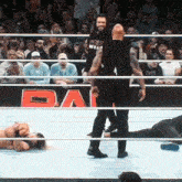two wrestlers in a ring with a sign that says ' buy ' on it
