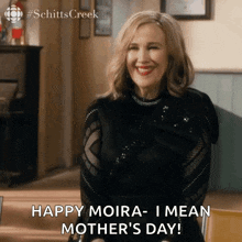 a woman from schitts creek is smiling and saying happy moira- i mean mother 's day