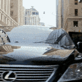 a black lexus car is parked in a city